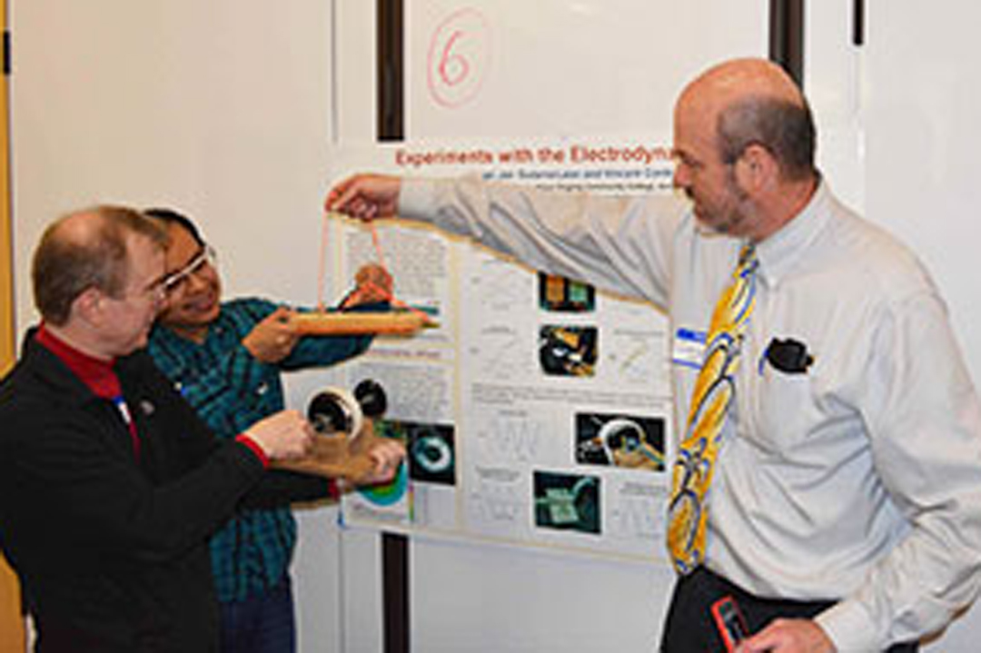 Faculty and students look at physics exhibits